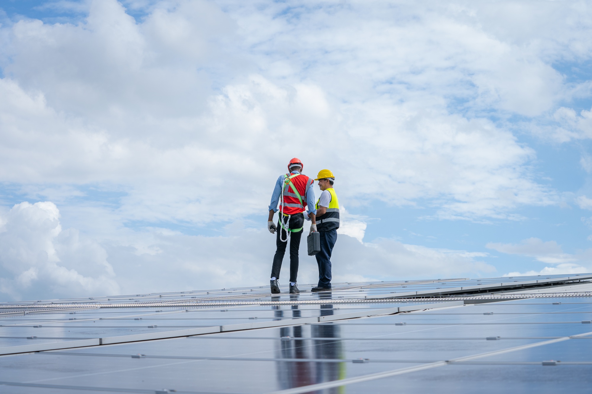 Engineer team working on replacement solar panel in solar power plant.